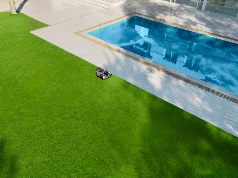 Sunseeker Elite X7 Plus Gen 2 robotic lawn mower, wide view of the mower on a large lawn