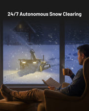 Yarbo Snow Blower clearing snow autonomously while the homeowner watches from indoors