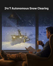 Yarbo Snow Blower clearing snow autonomously while the homeowner watches from indoors